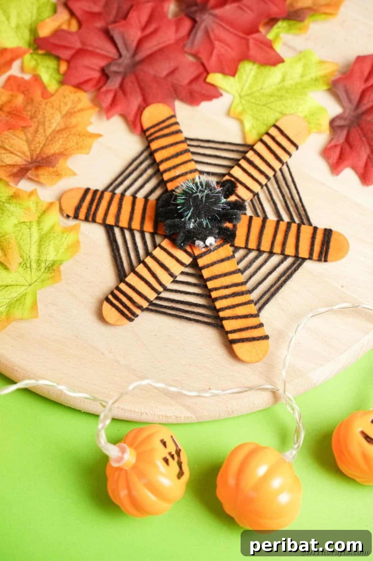 Spooky Stick Spiderwebs 19 A completed craft stick spider web, beautifully integrated into a Halloween table setting with autumnal elements.