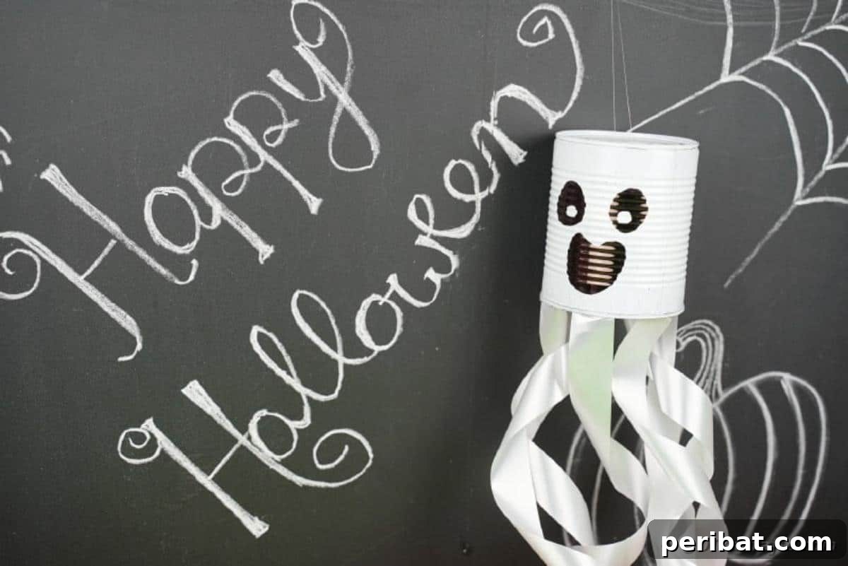 Haunting Tin Can Ghost Ornament 3 A friendly tin can ghost decoration displayed against a rustic chalkboard wall, highlighting its versatile appeal for indoor Halloween decorating.