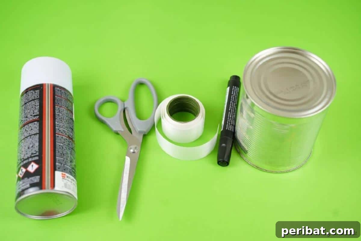 Haunting Tin Can Ghost Ornament 7 A flat lay photograph displaying all the simple materials needed to create a DIY tin can ghost, including a can, paint, markers, and ribbon.