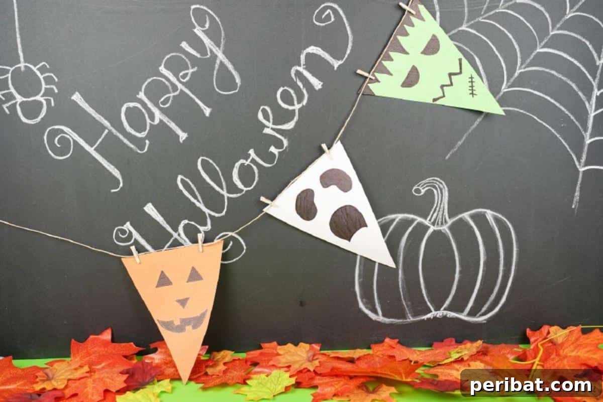 Halloween garland displayed on a chalkboard with other decorations