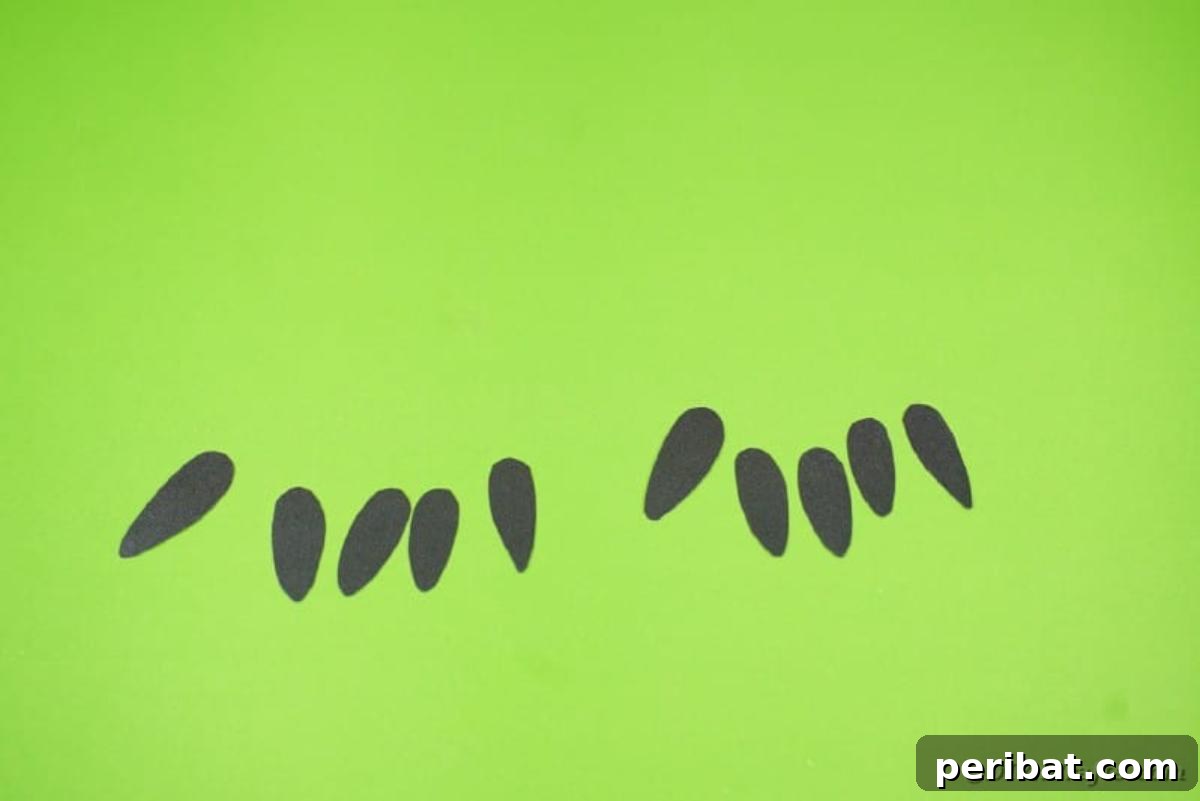 Creepy Popcorn Hand Snacks 13 Black paper fingernails on green table