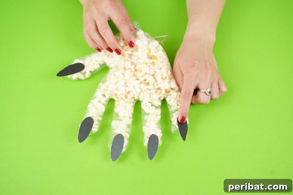 Creepy Popcorn Hand Snacks 15 Gluing nails on fingers of glove
