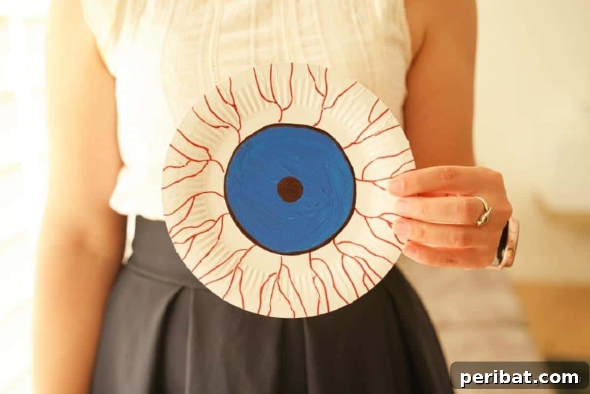 Staring Eyeball Halloween Plate Art 6 Woan holding blue bloodshot eye