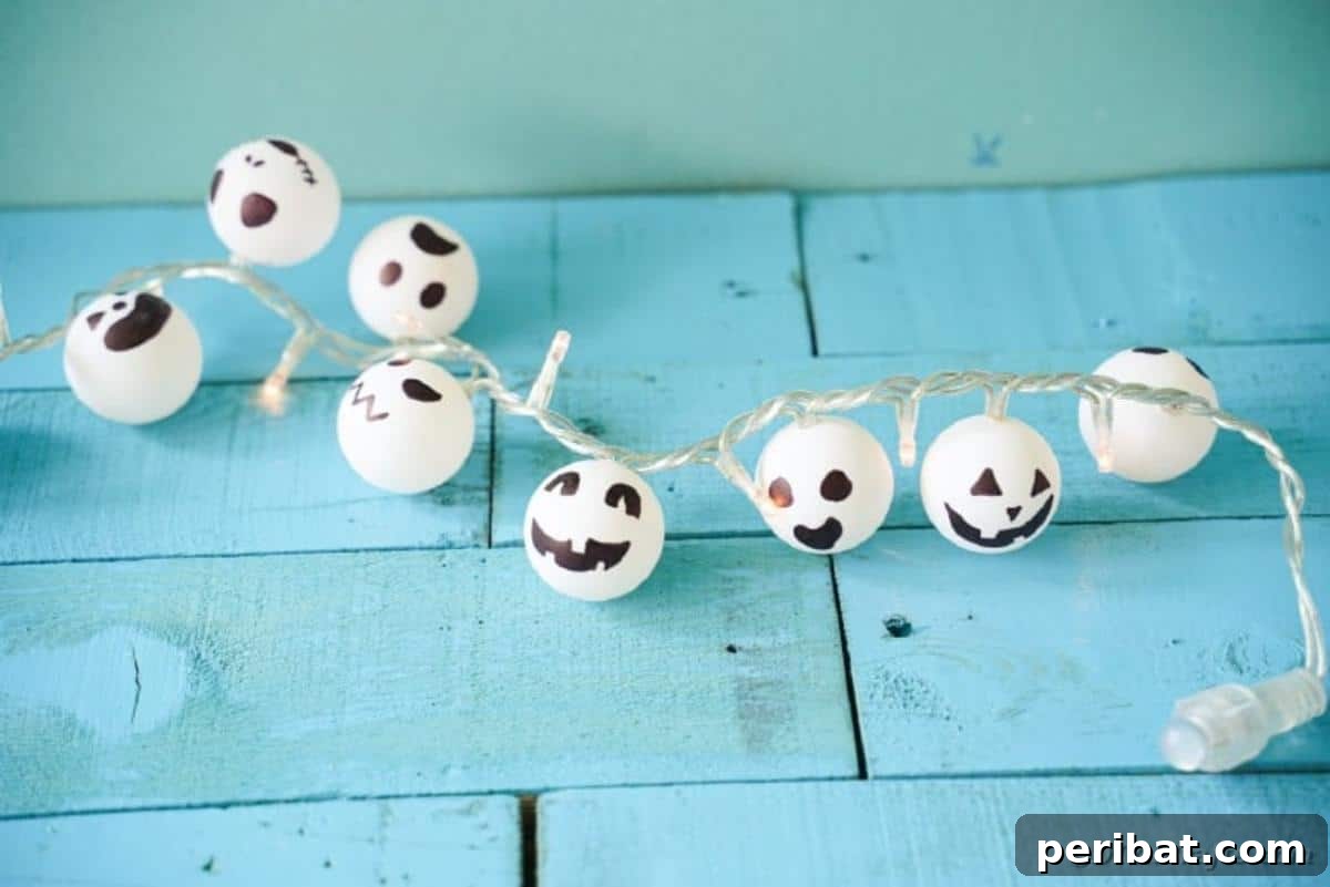 DIY Jack Skellington Halloween Garland with Ping Pong Balls 13 Jack Skellington twinkle lights on blue surface