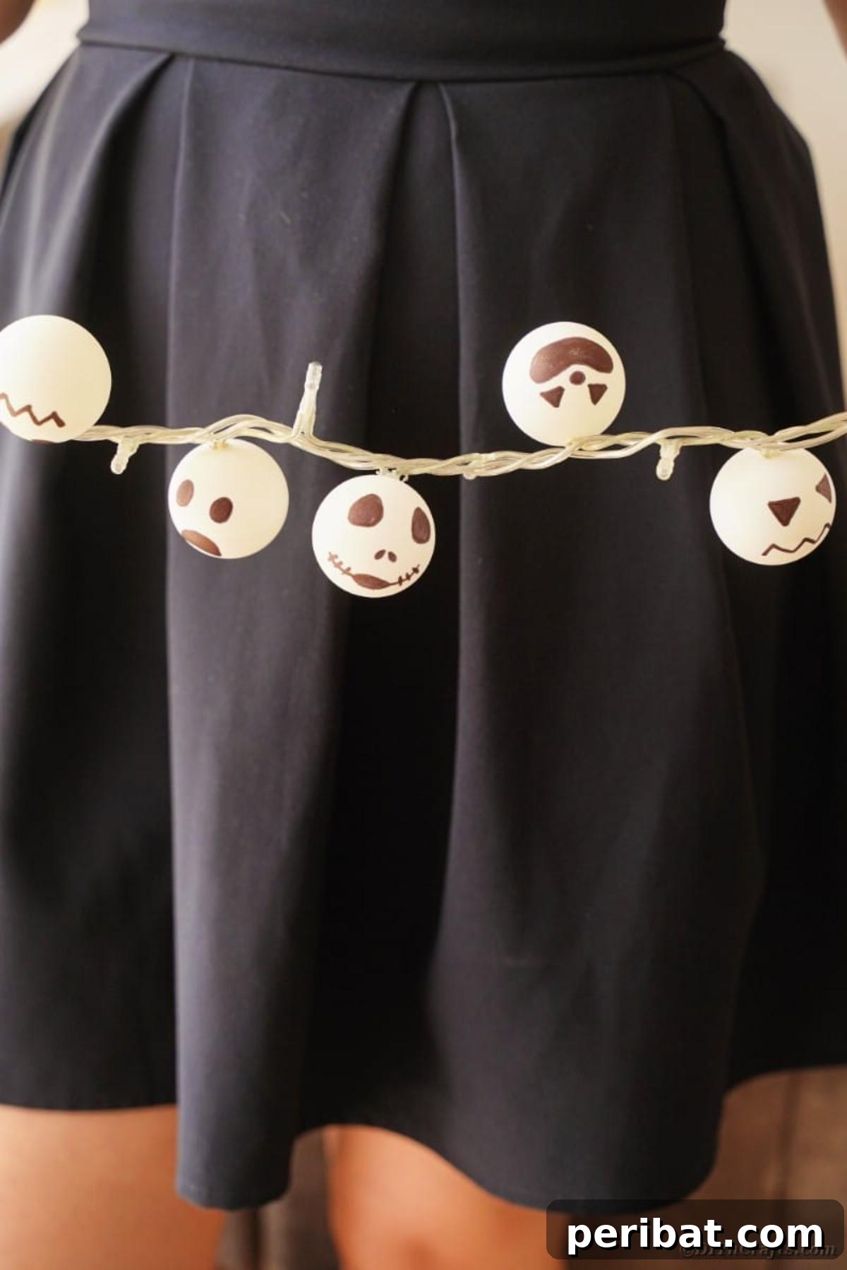 DIY Jack Skellington Halloween Garland with Ping Pong Balls 14 Woman holding Jack Skellington garland