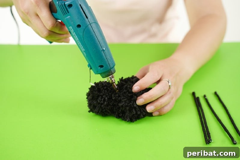 Gluing pom poms together