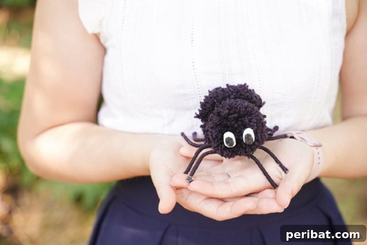 Woman holding a pom pom spider