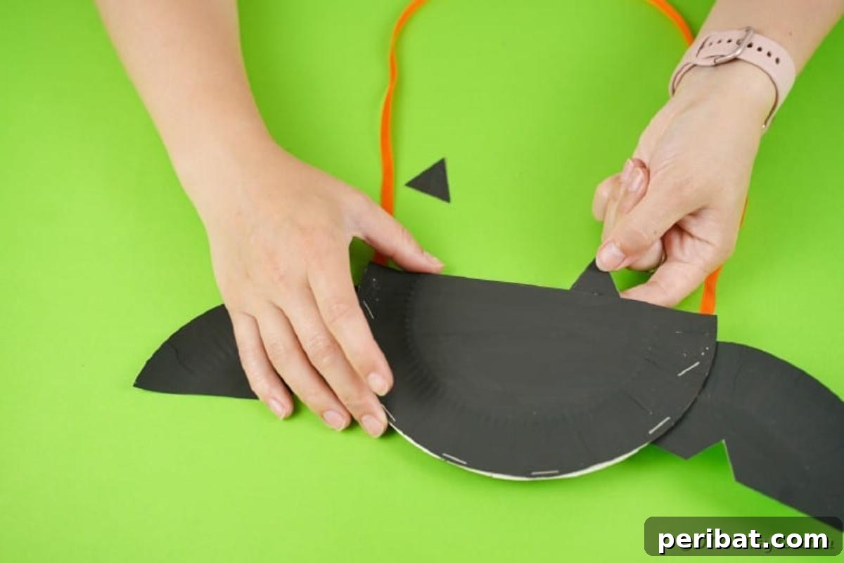 DIY Paper Plate Bat Candy Catchall 18 Attaching wings to paper plate bat