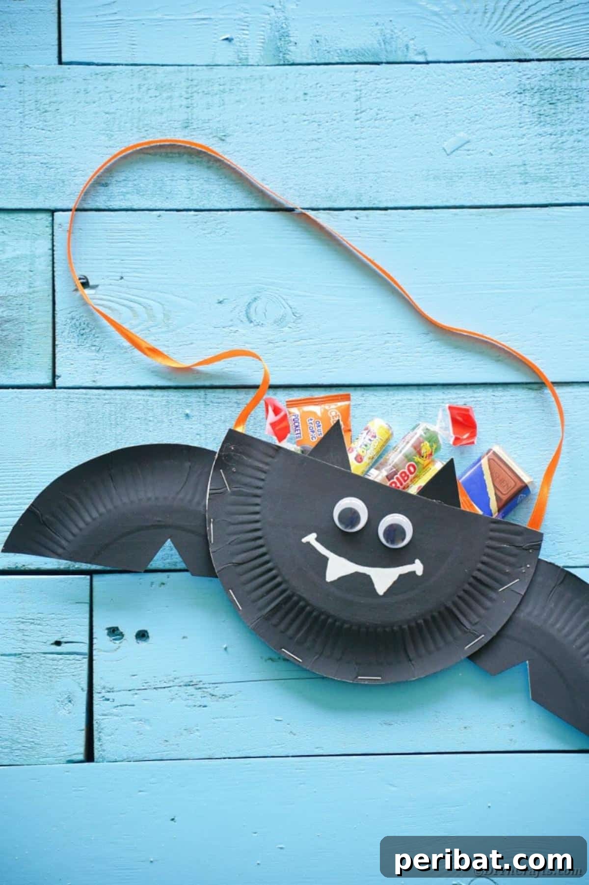 DIY Paper Plate Bat Candy Catchall 22 Bat filled with candy on blue boards