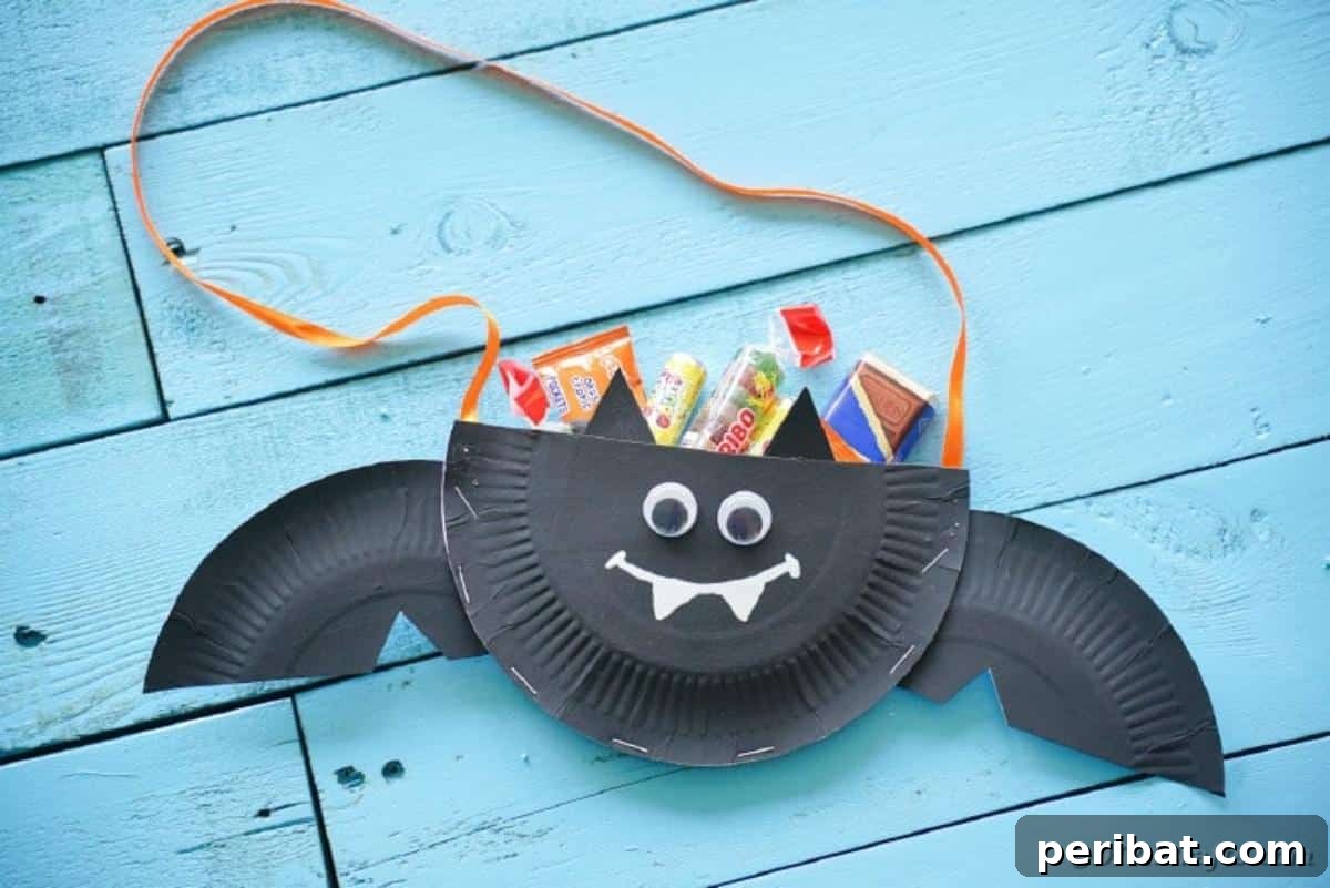 DIY Paper Plate Bat Candy Catchall 5 Bat filled with candy on blue boards