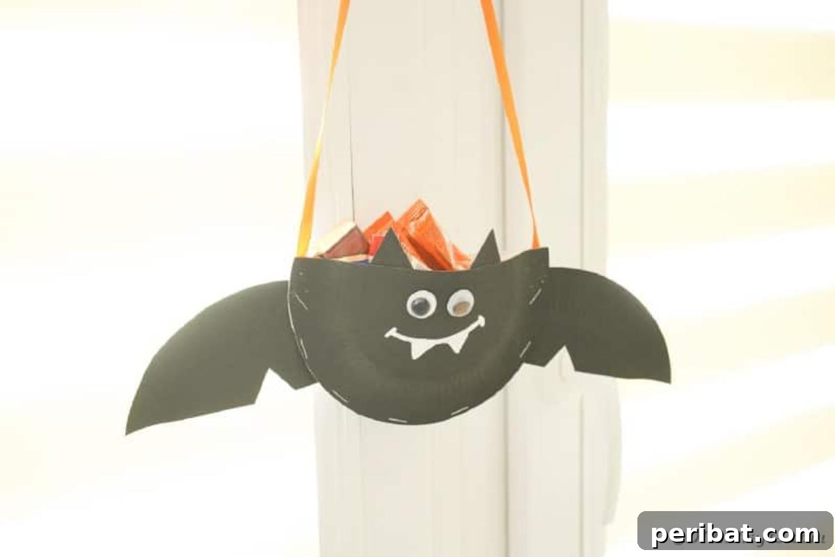 DIY Paper Plate Bat Candy Catchall 6 Paper bat hanging on doorknob