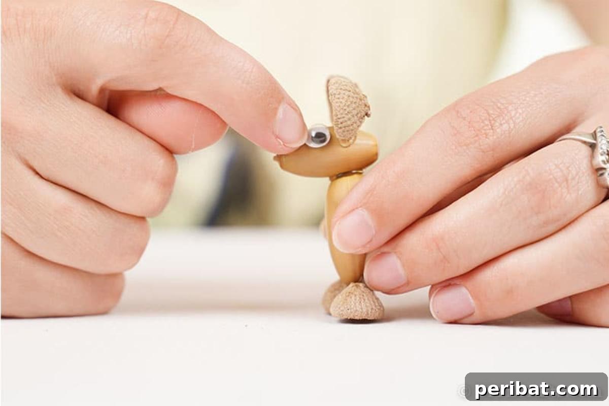 Craft Adorable Acorn Mice for Autumn Decor 11 Adding a googly eye to the acorn of a mouse animal decoration