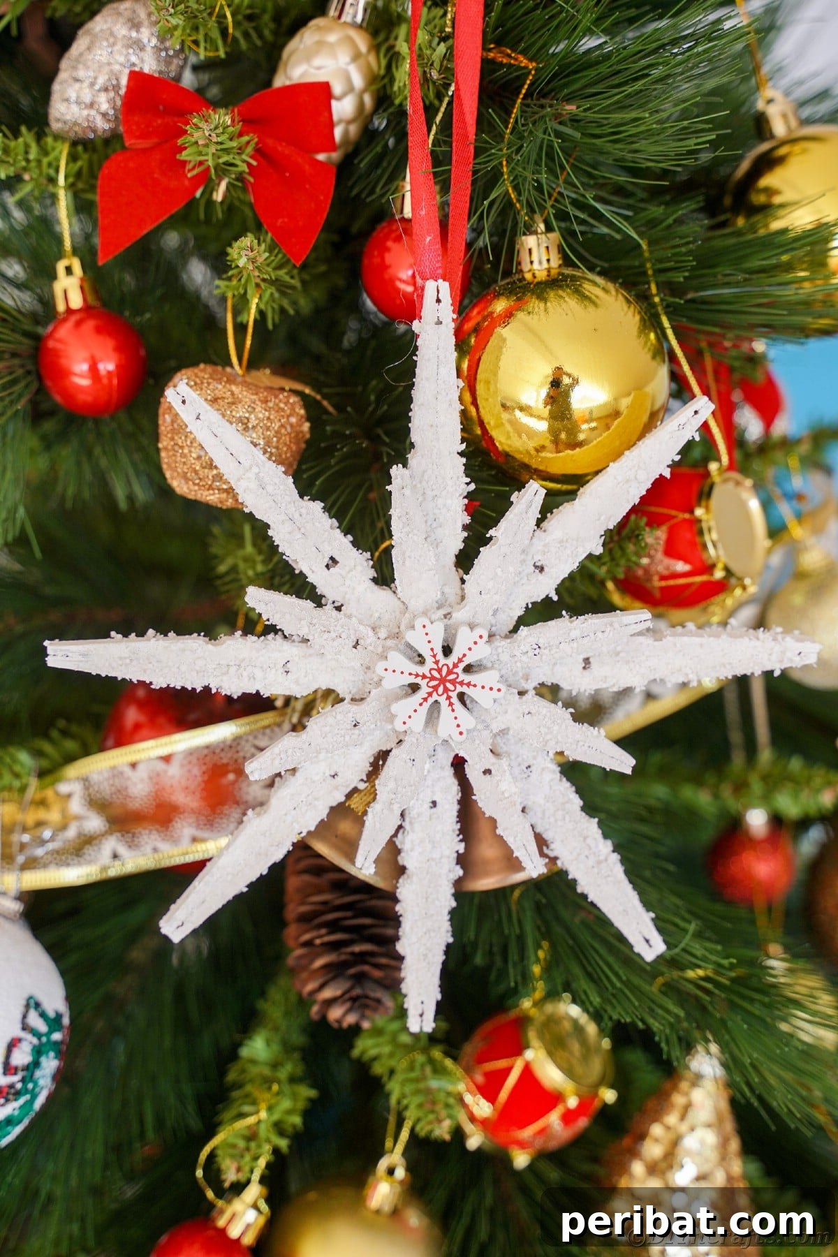 clothespin snowflake hanging on christmas tree