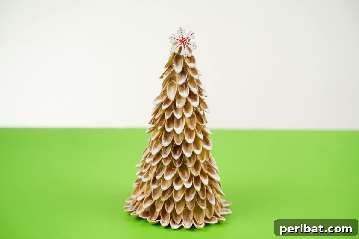 DIY Mini Christmas Trees from Upcycled Pistachio Shells 14 Finished pistachio nut craft handmade Christmas tree on a green table