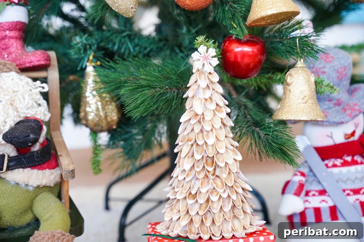 DIY Mini Christmas Trees from Upcycled Pistachio Shells 15 Nut shell craft in front of a Christmas tree
