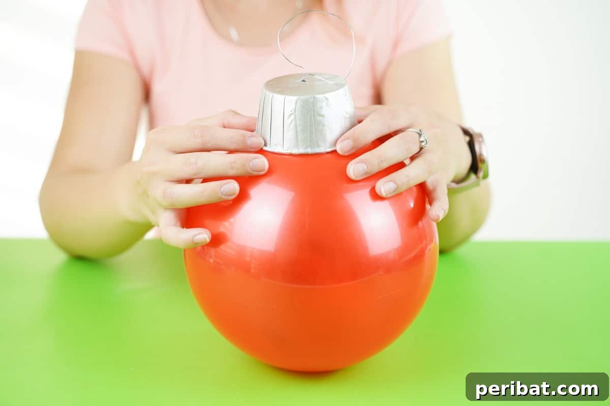 Attaching paper bowl cap to rubber ball base