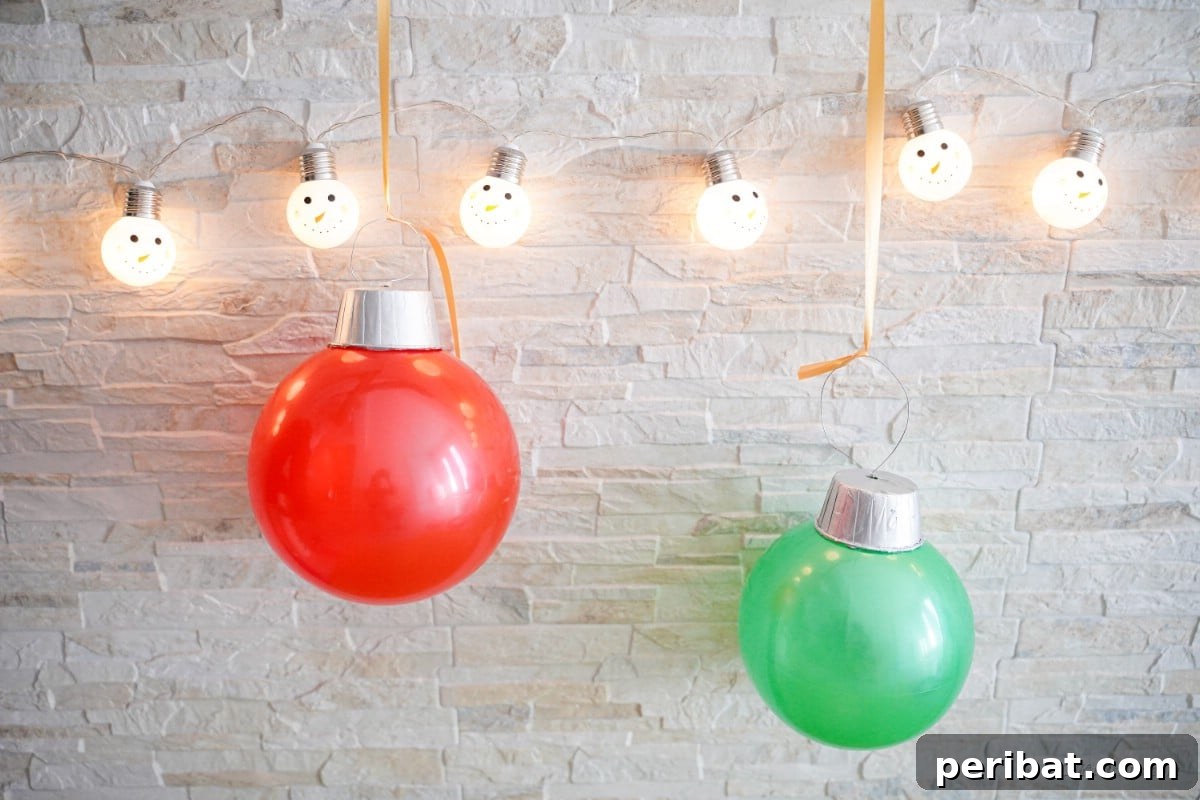 Giant ornaments made from rubber balls hanging from Christmas lights