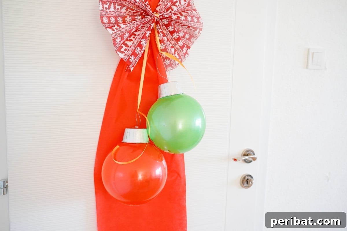 Large Christmas ornaments hanging from door with ribbon, showcasing versatility