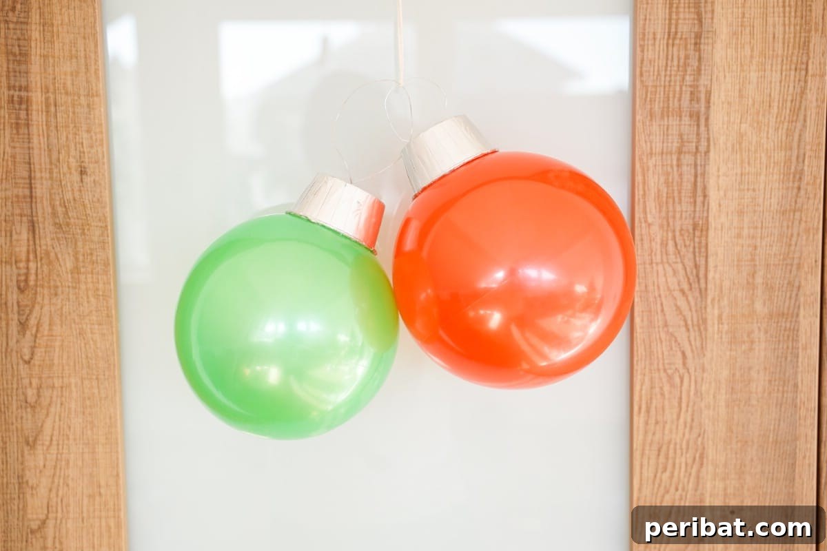 Hanging Christmas ball ornament on door with festive ribbon