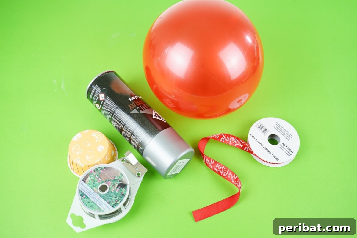 Supplies for making a giant ornament: rubber ball, spray paint, wire, bowl