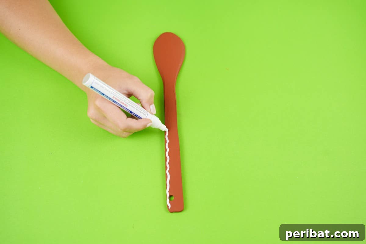 White paint marker painted wooden spoon craft