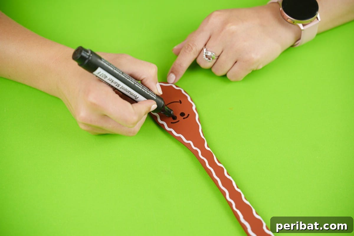 Marker drawing on wooden spoon for Christmas craft