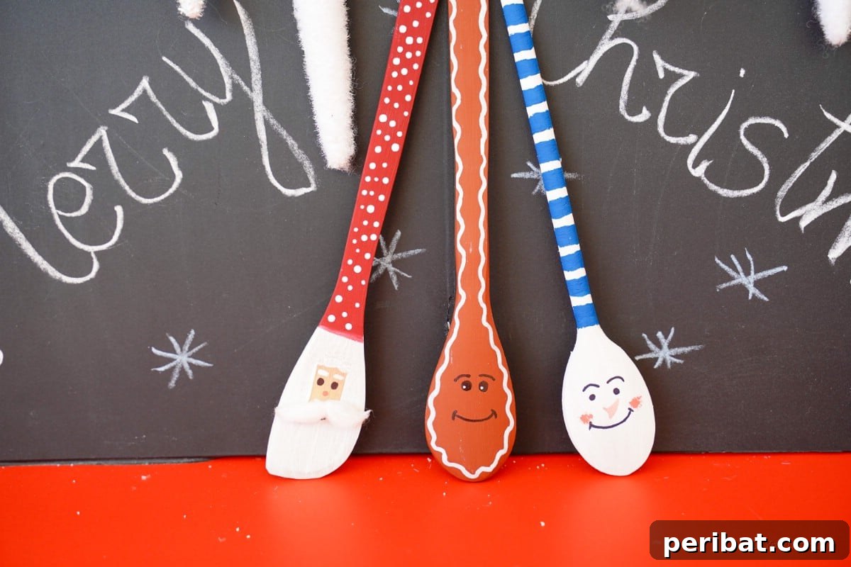 Christmas character wooden spoons in front of chalkboard 