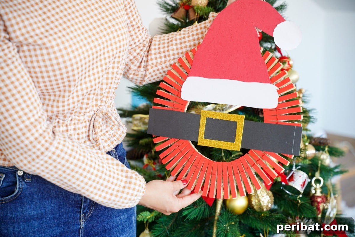 Craft a Delightful Santa Hat Wreath for Christmas 3 DIY Santa wreath craft idea hanging on a wall.