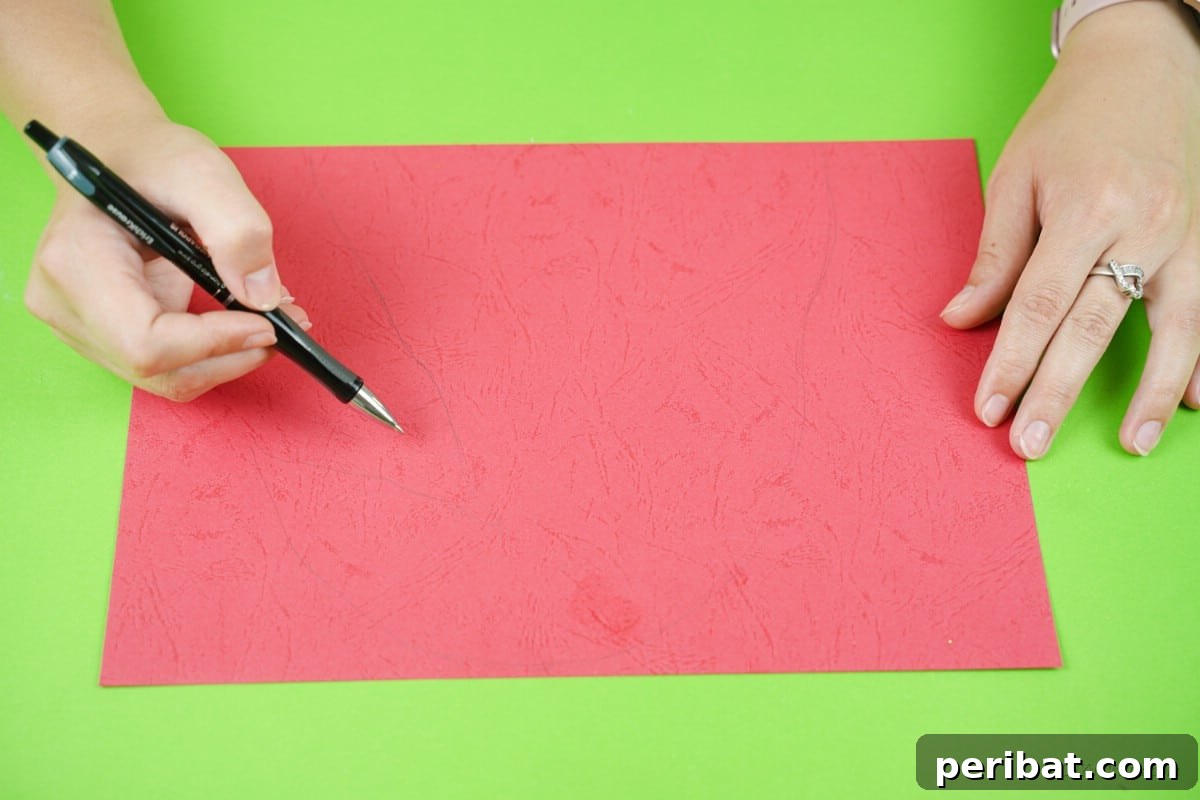 Craft a Delightful Santa Hat Wreath for Christmas 9 Tracing the Santa hat shape on red paper.