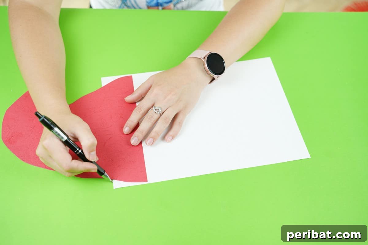 Craft a Delightful Santa Hat Wreath for Christmas 10 Working with craft supplies, the red paper hat cut out.
