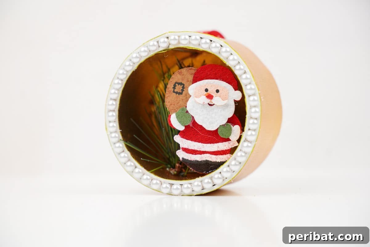 Whimsical Upcycled Santa 3D Christmas Tree Ornament 3 Close-up of a miniature Santa craft piece, highlighting the intricate diorama detail.
