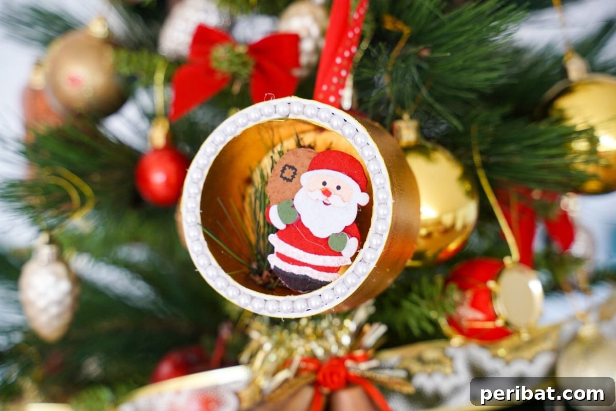 Whimsical Upcycled Santa 3D Christmas Tree Ornament 25 Finished craft hanging from the Christmas tree.