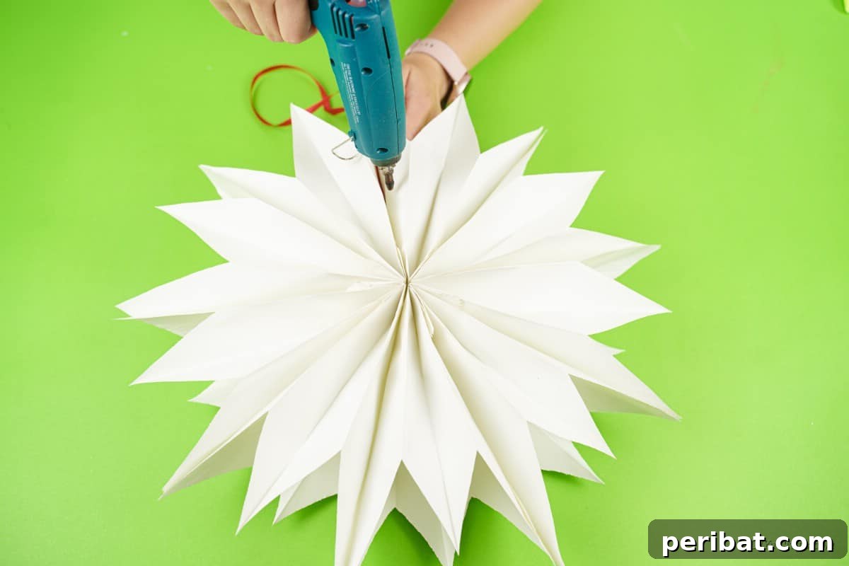 DIY Giant Paper Bag Star Decorations 13 Paper bag craft being glued with hot glue gun to secure its shape