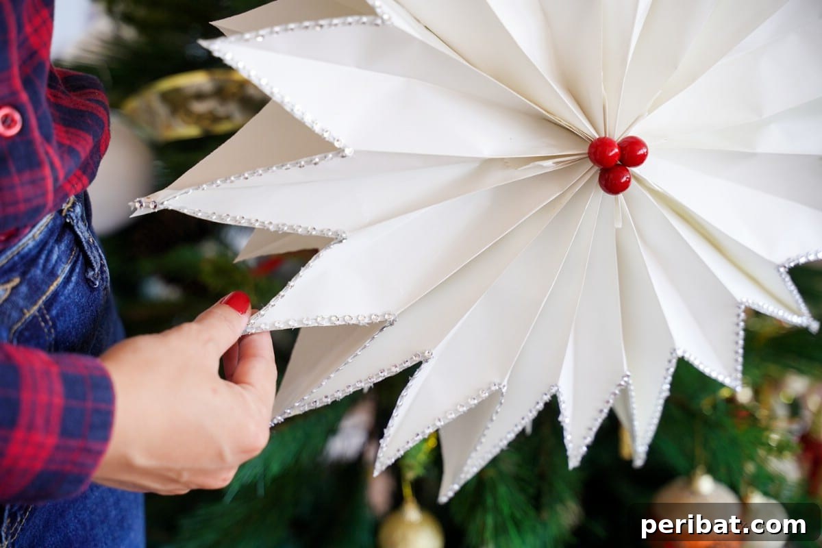 DIY Giant Paper Bag Star Decorations 6 Artistic huge star in front of Christmas tree, showcasing its festive appeal