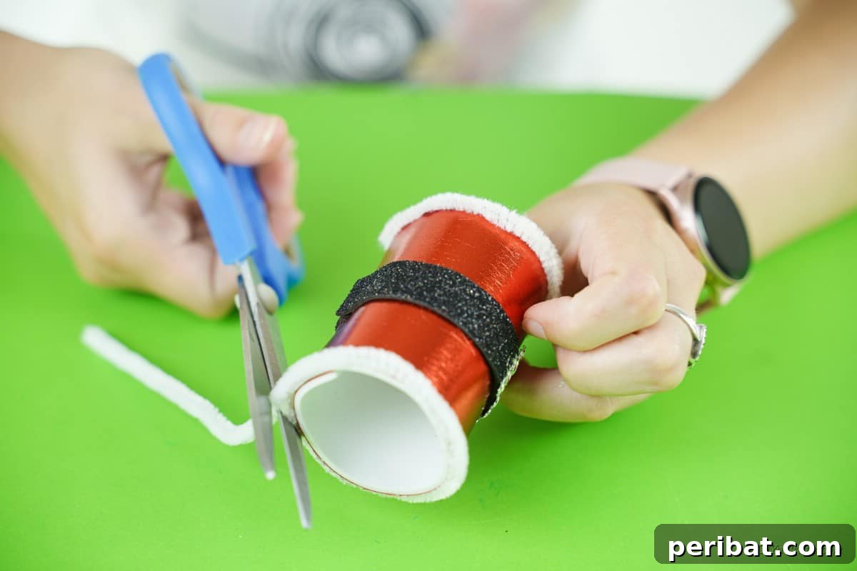 scissors cutting white pipe cleaner on craft