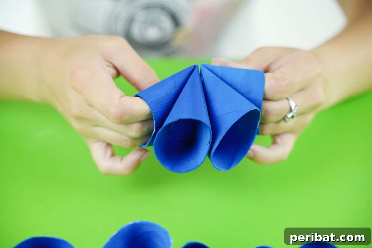 Roll-Upcycled Christmas Cheer 13 woman holding blue paper craft