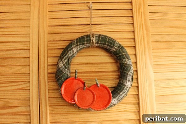 55+ Creative DIY Pumpkin Decorating Ideas for Fall 16 A delightful upcycled jar lid pumpkin patch wreath hanging on rustic wooden slat doors