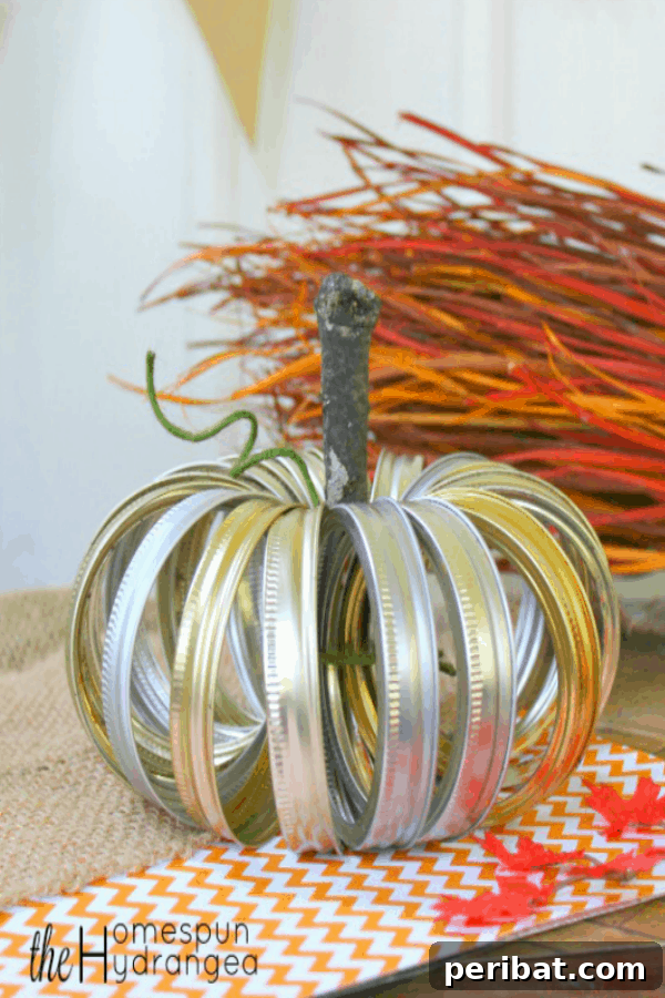 55+ Creative DIY Pumpkin Decorating Ideas for Fall 22 A rustic upcycled mason jar lid pumpkin craft displayed on a table, embodying farmhouse style