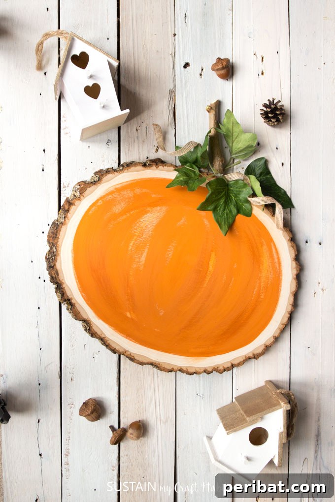 55+ Creative DIY Pumpkin Decorating Ideas for Fall 25 A creative pumpkin painted on a wood slice, doubling as a reversible chalkboard