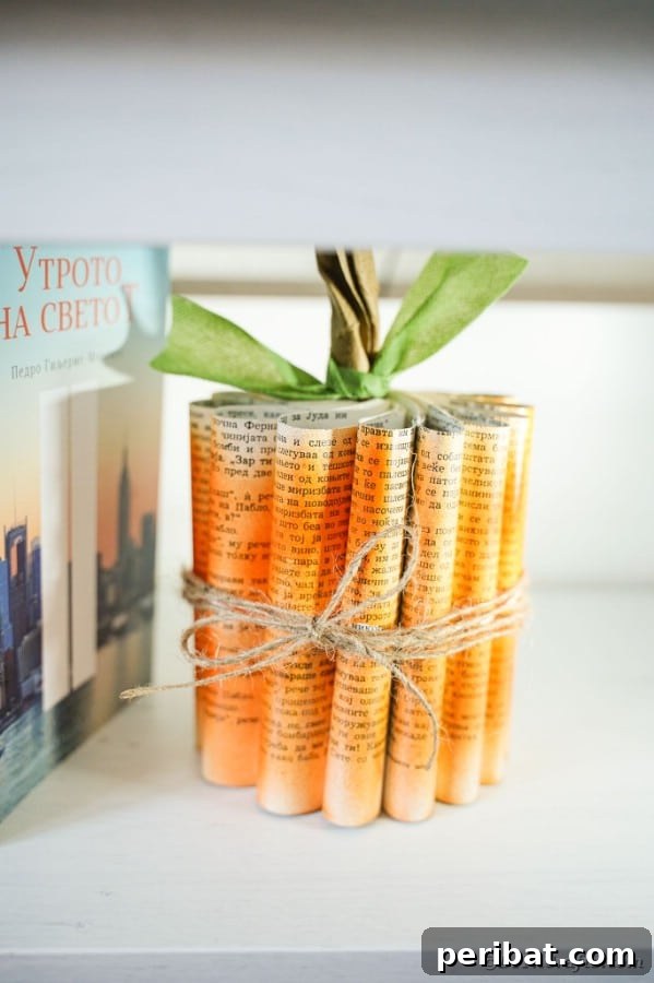 55+ Creative DIY Pumpkin Decorating Ideas for Fall 4 Elegant shabby chic paper pumpkin crafted from book pages, displayed beside a vintage book