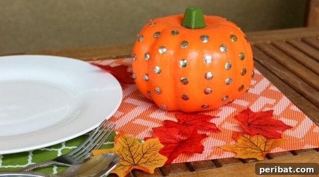 55+ Creative DIY Pumpkin Decorating Ideas for Fall 36 An elegant thumbtack pumpkin displayed on a festive fall placemat