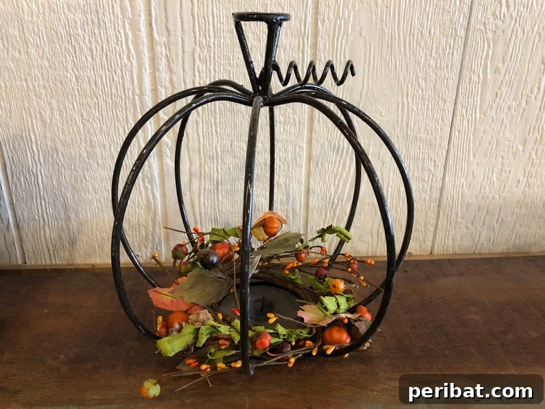 55+ Creative DIY Pumpkin Decorating Ideas for Fall 37 An artistic metal pumpkin decoration displayed on a table, offering an industrial chic vibe