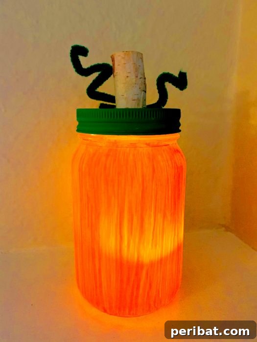 55+ Creative DIY Pumpkin Decorating Ideas for Fall 39 A charming mason jar pumpkin lantern sitting on a kitchen counter, radiating rustic warmth