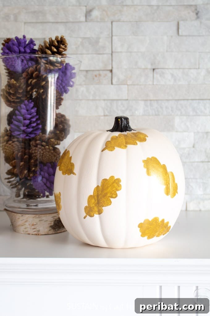 55+ Creative DIY Pumpkin Decorating Ideas for Fall 43 A graceful white pumpkin adorned with delicate gold leaves, exuding elegant Fall decor