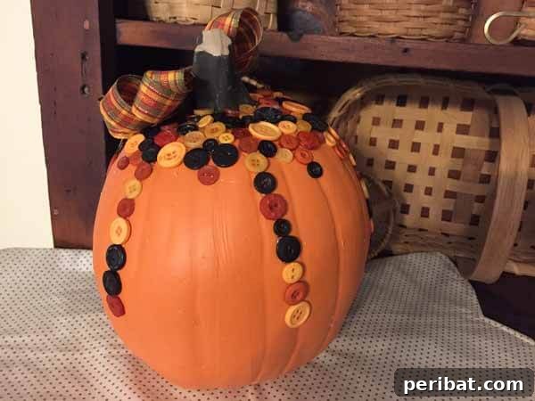 55+ Creative DIY Pumpkin Decorating Ideas for Fall 46 A rustic button pumpkin craft created on a plastic pumpkin, adorned with fall-colored buttons