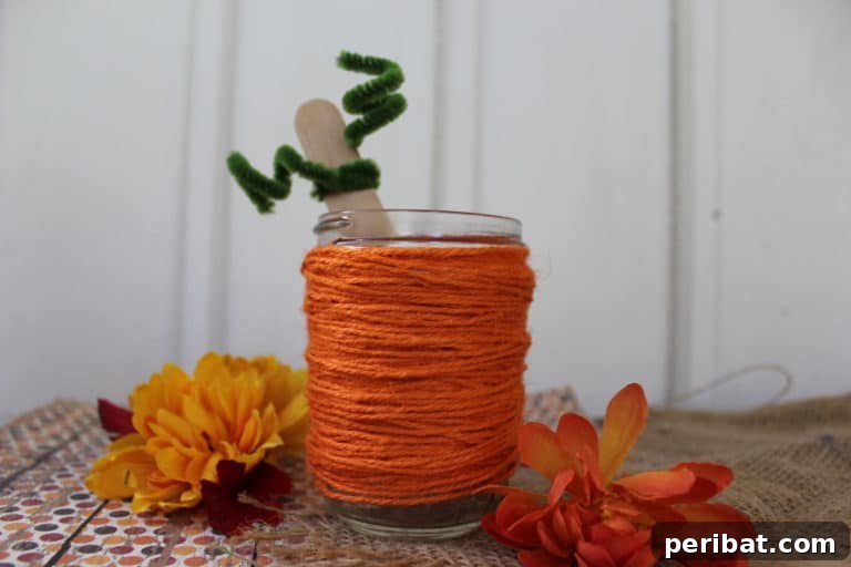 55+ Creative DIY Pumpkin Decorating Ideas for Fall 47 An adorable orange twine-wrapped mason jar, transformed into a pumpkin, resting on a table