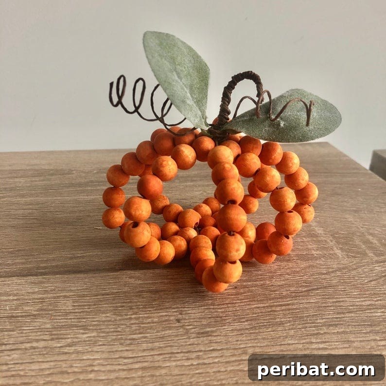 55+ Creative DIY Pumpkin Decorating Ideas for Fall 50 A charming rustic bead pumpkin decoration displayed on a table for Fall