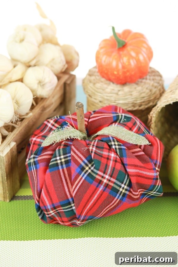 55+ Creative DIY Pumpkin Decorating Ideas for Fall 7 Rustic fabric pumpkin displayed against a weathered wooden crate, perfect for autumn decor