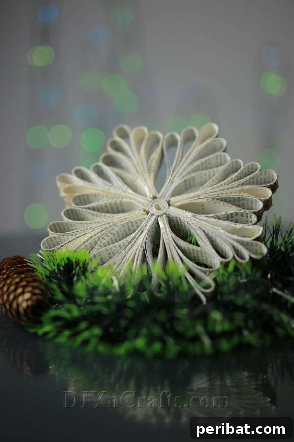 Sixty Sparkling DIY Ornaments for Your Christmas Tree 21 Old book snowflake on tree