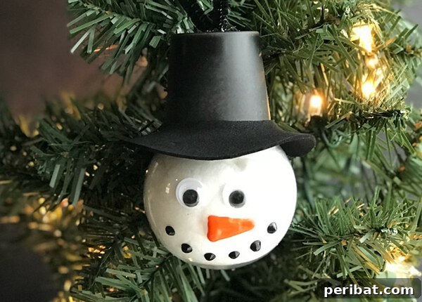 Sixty Sparkling DIY Ornaments for Your Christmas Tree 40 Snowman bulb with hat in tree